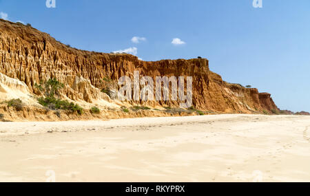 High cliffs along Falesia Beach and The Atlantic Ocean in Albufeira, Algarve, Portugal. Sunny summer day, blue sky. Stock Photo