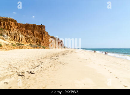 High cliffs along Falesia Beach and The Atlantic Ocean in Albufeira, Algarve, Portugal. Sunny summer day, blue sky. Stock Photo