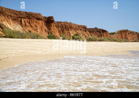 High cliffs along Falesia Beach and The Atlantic Ocean in Albufeira, Algarve, Portugal. Sunny summer day, blue sky. Stock Photo