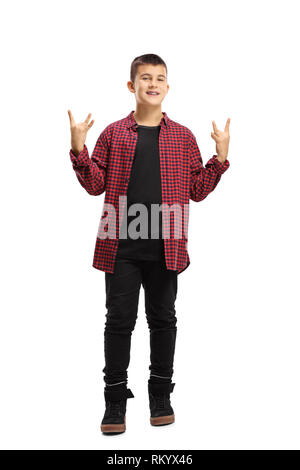 Full length portrait of a teenage boy making a hand gesture sign of the horns isolated on white background Stock Photo