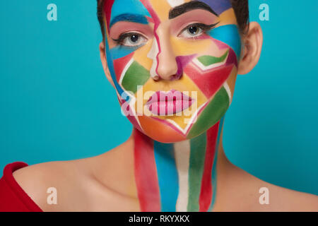 Cropped close up of creative and funky make up on face of model. Beautiful, pretty model looking at camera, posing. Confident and stylish girl has plump, pink lips. Stock Photo
