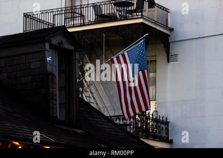 New Orleans, USA street closeup with American Flag in French Quarter of NOLA Louisiana with flagpole on roof Stock Photo