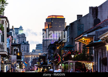 New Orleans, USA - April 22, 2018: Downtown old town Bourbon street in Louisiana famous town city at night evening sunset cityscape skyline with illum Stock Photo