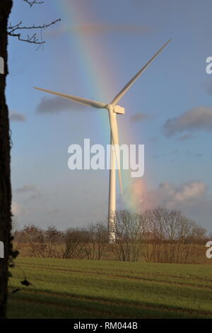 Wind turbine with a rainbow behind it Stock Photo