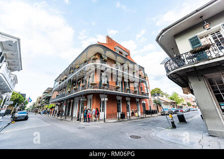 New Orleans, USA - April 23, 2018: Old town Royal street corner building in Louisiana famous city shops in evening with cast iron balconies and flower Stock Photo