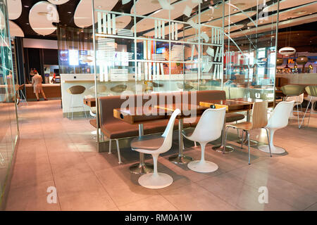 DUBAI, UAE - CIRCA NOVEMBER, 2016: McDonald's in Dubai International Airport. McDonald's is an American hamburger and fast food restaurant chain. Stock Photo