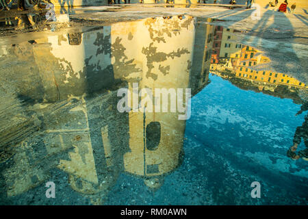 Basilica Santa Maria Assunta reflected on a sea water puddle in Camogli. Ligury, Genoa, Italy Stock Photo