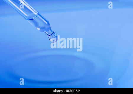 waterdrop with little waves from a pipette Stock Photo