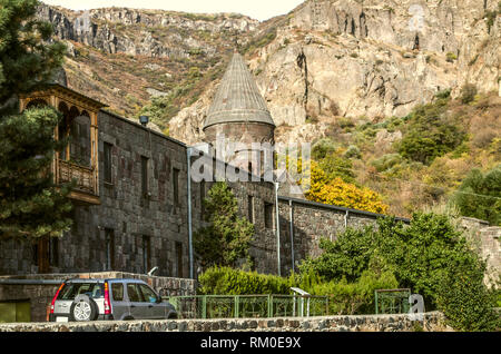 Kind of living quarters for the priests on the outside of the Geghard monastery in the gorge of Geghama mountain range on the background of  autumn tr Stock Photo