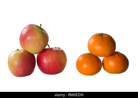 Apples and Oranges stacked in a group of three against a white background Stock Photo