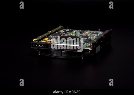 Used hard disk isolated on black background. Dusty old hdd. Stock Photo