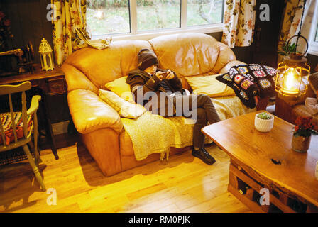 Nine year old boy playing on a smart phone, Medstead, Hampshire, England, United Kingdom. Stock Photo