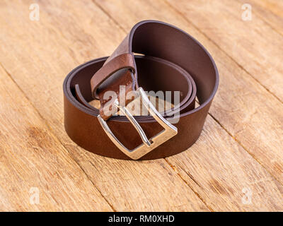 Stylish leather belt on wooden background Stock Photo