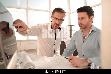 two architects discussing the project in the office Stock Photo