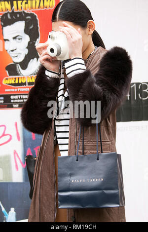 Young woman taking an instant photograph in the street. Travel Background Stock Photo