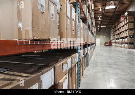 Cardboard boxes on shelves in warehouse Stock Photo
