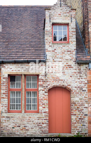 Freshly painted door on old European stone house in a color of the year 2019 Living Coral Pantone. Stock Photo