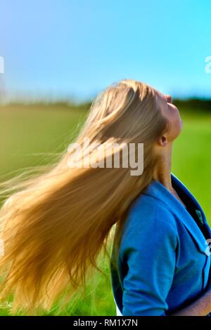 Woman shaking hair. Waakirchen, Bavaria, Germany.