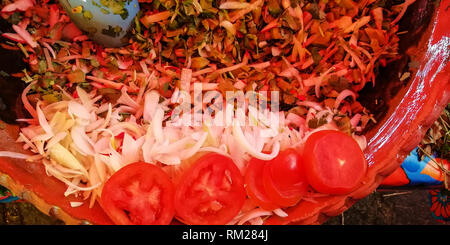 top view of a fresh mexican salad with onion, nopal and tomato, inside a handmade mexican clay pot Stock Photo