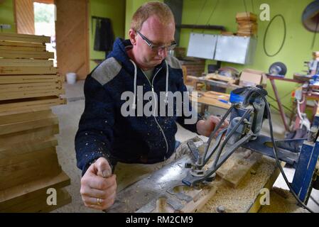 Master carpenter at work in the workshop outdoors 