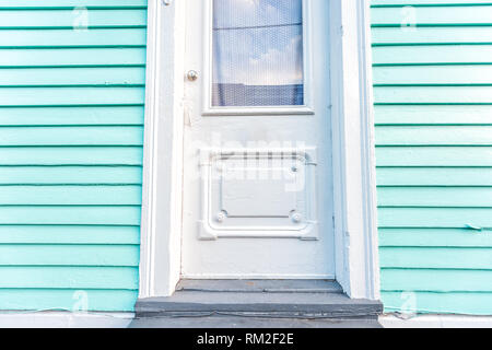 New Orleans, USA Old town Royal street in Louisiana famous town city and closeup of turquoise blue green colorful door wall on building home Stock Photo