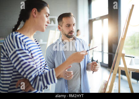 Conversation by easel Stock Photo
