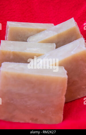 Hand crafted soaps on a red cloth. Stock Photo
