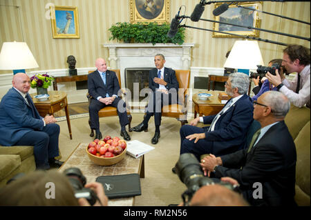 United States President Barack Obama meets retired NASA astronaut Scott Kelly and his brother Mark in the Oval Office of the White House in Washington, DC on Friday, October 21, 2016.  From left to right: Former NASA astronaut Mark Kelly; Scott Kelly; President Obama; John P. Holdren, Assistant to the President for Science and Technology, Director of the White House Office of Science and Technology Policy, and Co-Chair of the President’s Council of Advisors on Science and Technology; and Major General Charles Bolden, Jr., (USMC-Retired), NASA Administrator. Credit: Ron Sachs / Pool via CNP /Me Stock Photo
