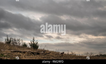 Looking Up at Storm Clouds With Small Hill in the Foreground Stock Photo