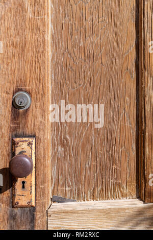 Door knob on an old wooden door Stock Photo