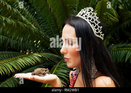 Johannesburg, South Africa - February 08 2013: Princess kissing a frog in a garden Stock Photo