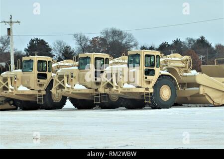 Military vehicles are parked at a training area on the cantonment area Feb. 1, 2019, at Fort McCoy, Wis. Thousands of troops trained at Fort McCoy in February for various training events. (U.S. Army Photo by Scott T. Sturkol, Public Affairs Office, Fort McCoy, Wis.) Stock Photo