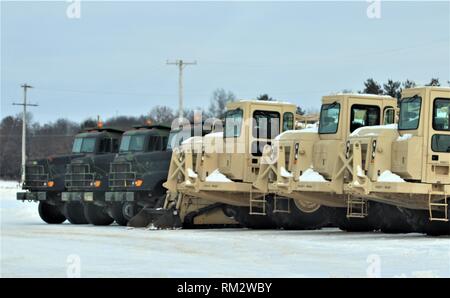 Military vehicles are parked at a training area on the cantonment area Feb. 1, 2019, at Fort McCoy, Wis. Thousands of troops trained at Fort McCoy in February for various training events. (U.S. Army Photo by Scott T. Sturkol, Public Affairs Office, Fort McCoy, Wis.) Stock Photo