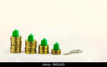 House key and mini houses about the coins , Real estate investment, save money with stack coin, business growth investment and financial, renting home Stock Photo