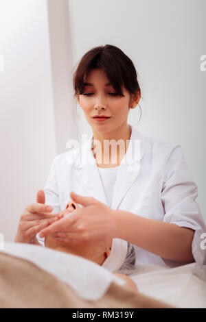 Pleasant nice woman working in the beauty clinic Stock Photo