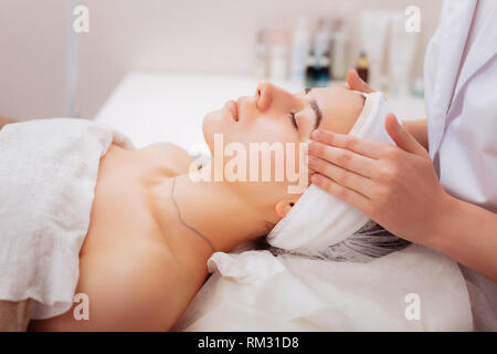 Pleasant attractive young woman feeling very peaceful Stock Photo