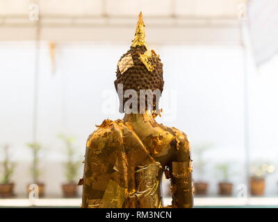 Gold plates On the back of buddha statue at The Thai Temple in Lampang, Thailand. Stock Photo