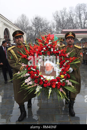 (190213) -- KABUL, Feb. 13, 2019 (Xinhua) -- Afghan honor guard carry a portrait of Afghan former president Sibghatullah Mujaddadi during a funeral ceremony in Kabul, capital of Afghanistan, Feb. 13, 2019. The body of former Afghan President Sibghatullah Mujaddadi was laid to rest in his ancestral graveyard here in Kabul on Wednesday amid tight security.     Hundreds of people including President Mohammad Ashraf Ghani, his predecessor Hamid Karzai and cabinet ministers, attended the funeral ceremony performed in the Presidential Palace. (Xinhua/Rahmat Alizadah) Stock Photo