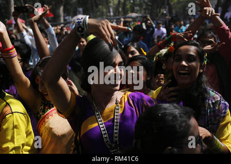 Dhaka, Bangladesh. 13th Feb, 2019. A Tran's woman dance with others as she participates to celebrate Basanta Utsab (Spring Festival) in the Dhaka University campus. Pohela Falgun, the first day of the spring season of Bengali month Falgun, celebrate with flowers, poems, songs and dance across the country. Credit: MD Mehedi Hasan/ZUMA Wire/Alamy Live News Stock Photo