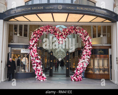 Mayfair, London, UK. 13 February, 2019. A giant pink heart decorates the entrance to Burlington Arcade for Valentines Day in the heart of the capital’s shopping destination. Credit: Malcolm Park/Alamy Live News. Stock Photo