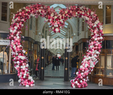 Mayfair, London, UK. 13 February, 2019. A giant pink heart decorates the entrance to Burlington Arcade for Valentines Day in the heart of the capital’s shopping destination. Credit: Malcolm Park/Alamy Live News. Stock Photo