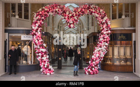 Mayfair, London, UK. 13 February, 2019. A giant pink heart decorates the entrance to Burlington Arcade for Valentines Day in the heart of the capital’s shopping destination. Credit: Malcolm Park/Alamy Live News. Stock Photo