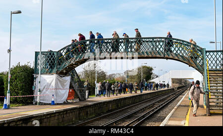 Brighton, UK. 13th Feb, 2019. Punters arrive by train as racing is back under way again at Plumpton Racecourse in Sussex after the recent suspension of horse racing throughout Britain due to an outbreak of equine flu Credit: Simon Dack/Alamy Live News Stock Photo