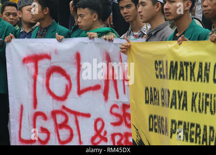 Bogor, West Java, Indonesia. 13th Feb, 2019. Protesters are seen holding banners during the protest.A number of protesters were seen holding placards and banners when they rejected Valentine's Day celebrations (February 14) at Tugu Kujang, Bogor, They invite teenagers to study religious matters more than to participate in Valentine's Day celebrations. Credit: Adriana Adinandra/SOPA Images/ZUMA Wire/Alamy Live News Stock Photo