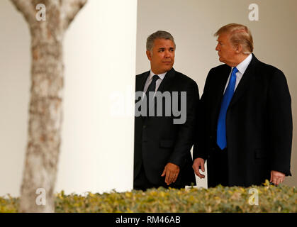 Washington DC, USA. 13th Feb, 2019. United States President Donald J. Trump, right, walks with President Iván Duque of Colombia, left, along the West Wing collonade of the White House, in Washington, DC, February 13, 2019. Credit: Martin H. Simon/CNP /MediaPunch Credit: MediaPunch Inc/Alamy Live News Stock Photo