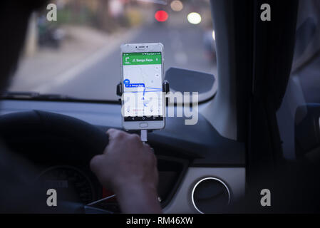 Dki Jakarta, DKI Jakarta, Indonesia. 13th Feb, 2019. An on-line taxi driver seen using gps navigate which was mounted above the car dashboard to provide driving direction at Jakarta, Indonesia.Indonesian Constitutional Court has ruled that checking the GPS on a mobile phone while driving is punishable by up to three months' imprisonment, as stipulated in the 2009 Traffic Law. Credit: Agung Fatma Putra/SOPA Images/ZUMA Wire/Alamy Live News Stock Photo