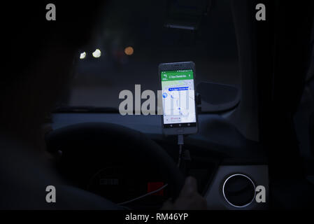 Dki Jakarta, DKI Jakarta, Indonesia. 13th Feb, 2019. An on-line taxi driver seen using gps navigate which was mounted above the car dashboard to provide driving direction at Jakarta, Indonesia.Indonesian Constitutional Court has ruled that checking the GPS on a mobile phone while driving is punishable by up to three months' imprisonment, as stipulated in the 2009 Traffic Law. Credit: Agung Fatma Putra/SOPA Images/ZUMA Wire/Alamy Live News Stock Photo