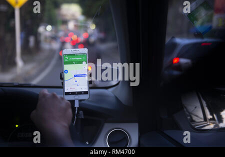 Dki Jakarta, DKI Jakarta, Indonesia. 13th Feb, 2019. An on-line taxi driver seen using gps navigate which was mounted above the car dashboard to provide driving direction at Jakarta, Indonesia.Indonesian Constitutional Court has ruled that checking the GPS on a mobile phone while driving is punishable by up to three months' imprisonment, as stipulated in the 2009 Traffic Law. Credit: Agung Fatma Putra/SOPA Images/ZUMA Wire/Alamy Live News Stock Photo