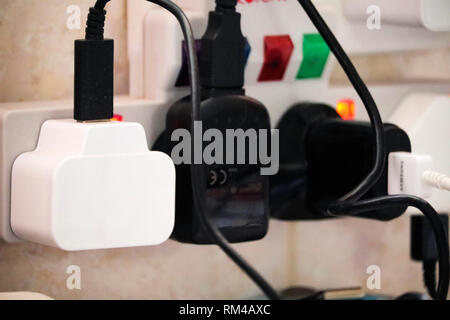 Electric plugs in sockets Stock Photo