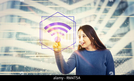 Woman pressing a digital screen interface selecting wifi symbol hologram. Global network concept, excellent signal coverage. Stock Photo